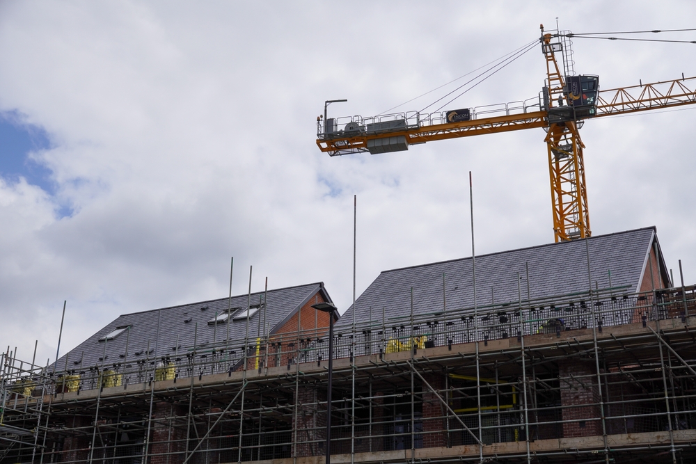 large crane and scaffolding at site of new housing development in city of Southampton. construction of new apartment buildings