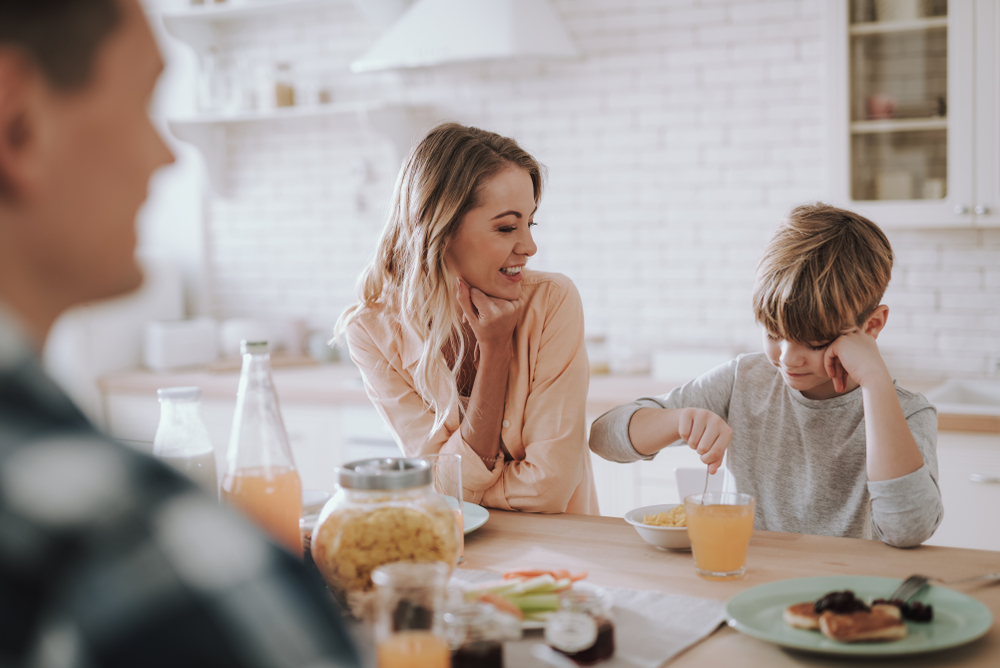woman standing in the kitchen near her son 