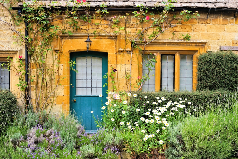 Charming Cotswolds house front with flowers
