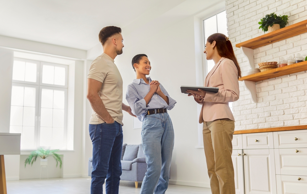 Estate agent showing home to couple