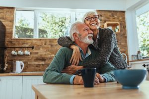 Mature couple embracing at home