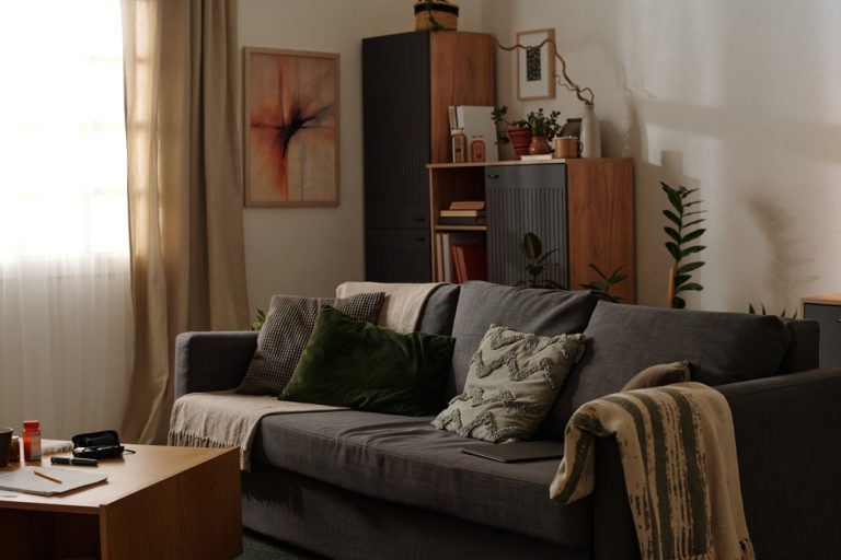 Stylish living room featuring green and gray furnishings with modern art on walls