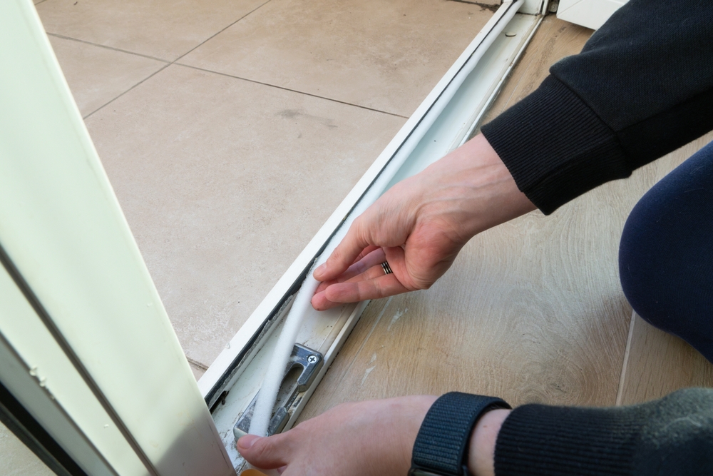 Saving Energy Insulating Home Putting Draught Excluder Tape On Window
