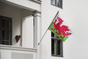 Welsh flag hanging on a pole in front of the house