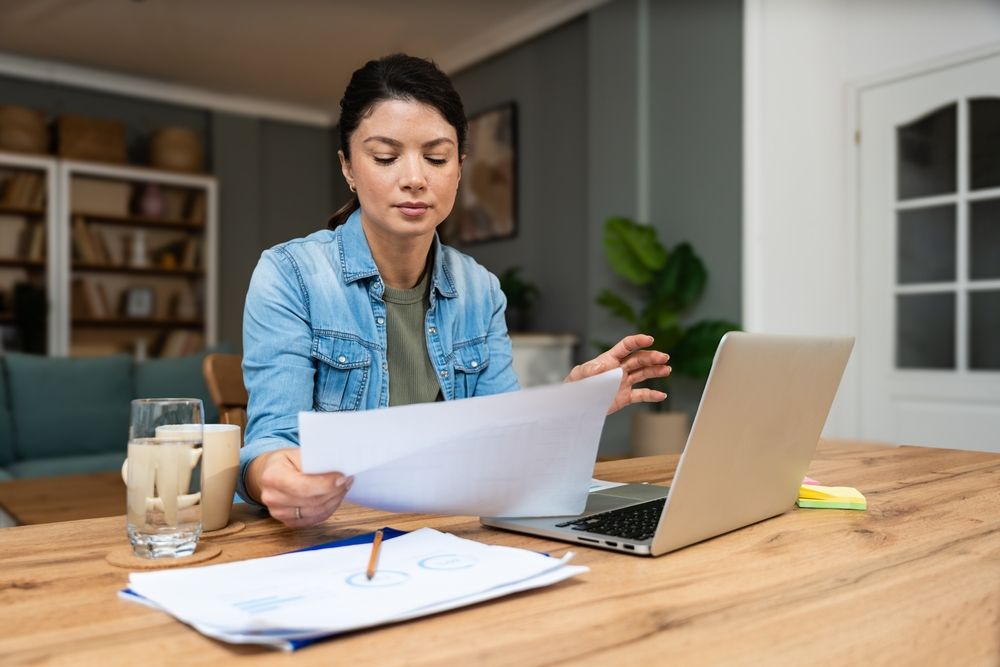 woman working at home office on laptop computer